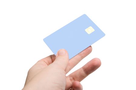 Hand with credit card isolated on white (focus on card)の写真素材