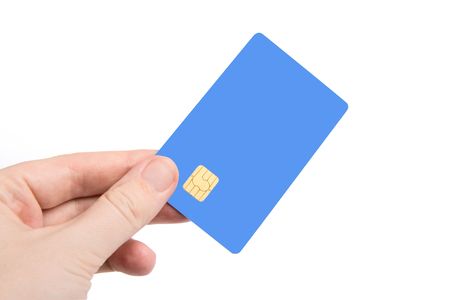 Hand with credit card isolated on white (focus on card)の写真素材