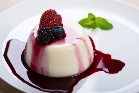 panna cotta with sauce of  strawberry and blackberries, closeup の写真素材