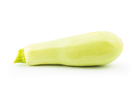 One whole bright green zucchini on white backgroundの写真素材