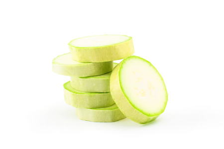 Pieces of bright green zucchini on white backgroundの写真素材