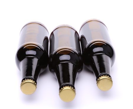 Lying three bottles of beer on white background.の写真素材