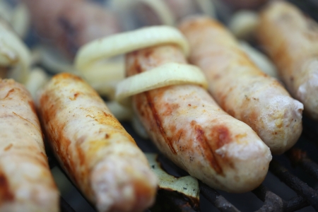 BBQ a few sausages with onionの写真素材