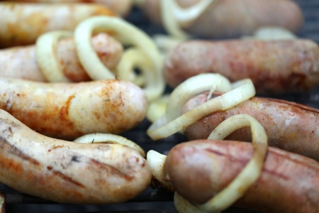 BBQ a lot of sausages with onionの写真素材