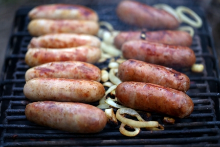 A lot of bratwurst sausages on grill.の写真素材