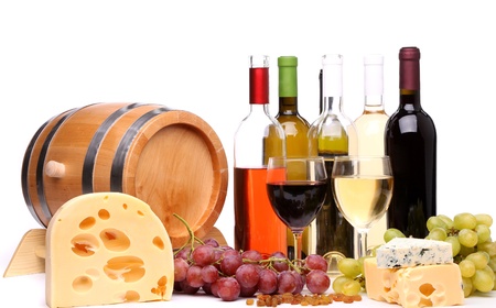 barrel, cheeses, bottles and glasses of wine and ripe grapes on woodenの写真素材
