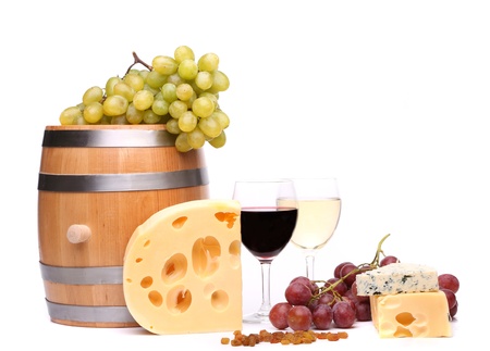 barrel, cheeses, glasses of wine and ripe grapes on woodenの写真素材
