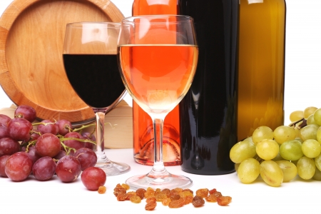 barrel, bottles and glasses of wine and ripe grapes on woodenの写真素材