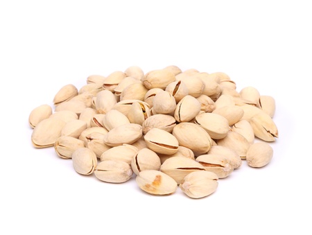 A pistachios heap on the white background close-upの写真素材