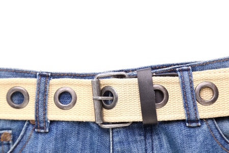 Blue jeans and leather white belt on the white backgroundの写真素材