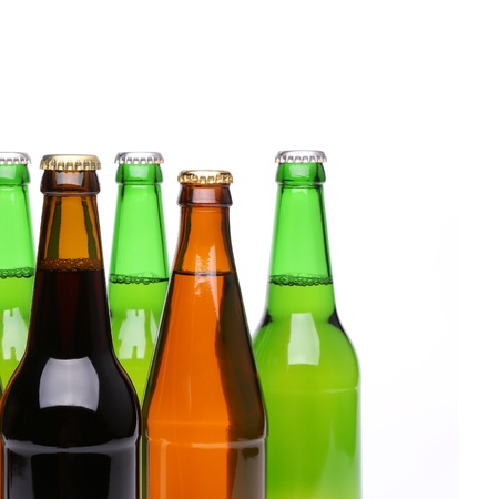 Closed bottles of beer are located left on a white backgroundの写真素材