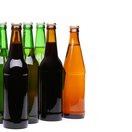 Closed bottles of beer are located left on a white backgroundの写真素材