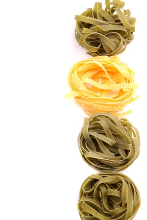 Tagliatelle paglia e fieno homemade tipycal italian pasta close-up on the white background の写真素材
