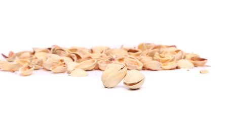 Two pistachios and peel on the white background の写真素材