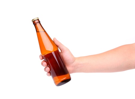 A hand holding up a yellow beer bottle without label over a white background vertical formatの写真素材
