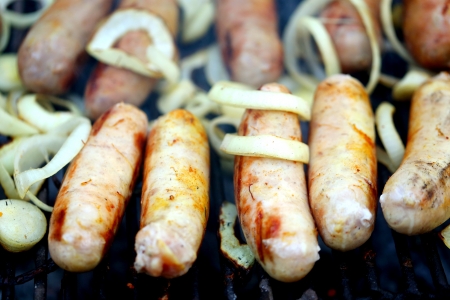 BBQ a lot of sausages with onionの写真素材