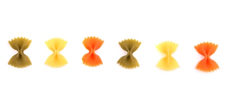Pasta farfalle three colors are located on the white background.の写真素材