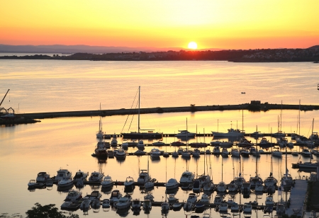 Ships, boats and yachts in harbor with dramatic beautiful sunsetの写真素材