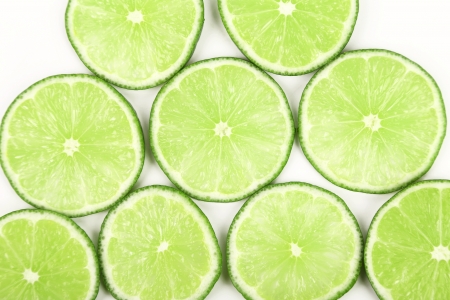lime slices neatly arranged on a white backgroundの写真素材