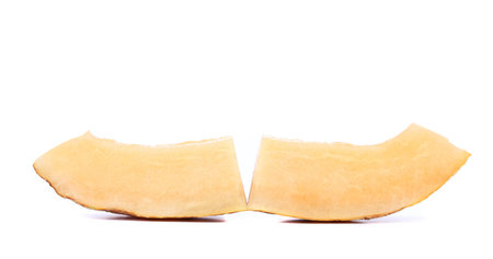 Melon slices cut in half on a white background