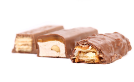 Different slices bar of chocolate. Close up. White background.