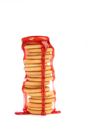 Stream red syrop and stake biscuit sandwich. White background.の写真素材