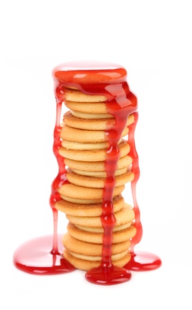 Stream red syrop and stake biscuit sandwich. White background.の写真素材