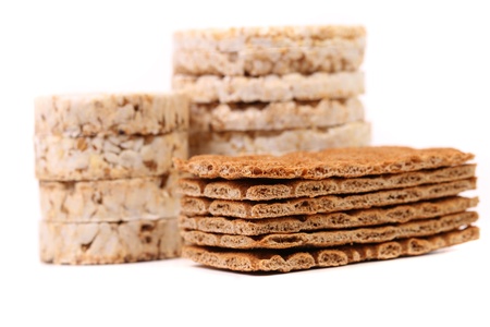 Composition of corn cracker and bread crisps. White background.の写真素材