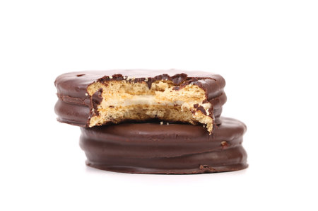 Bitten biscuit sandwich with chocolate. White background.の写真素材