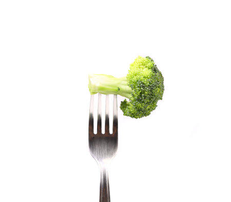 Broccoli impaled on a fork. White background.の写真素材
