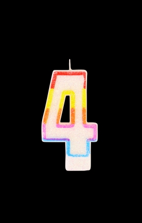 Candle in the form of four figures. Black background.の写真素材