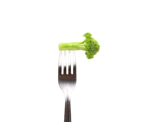 Fresh broccoli on a fork. White background.の写真素材