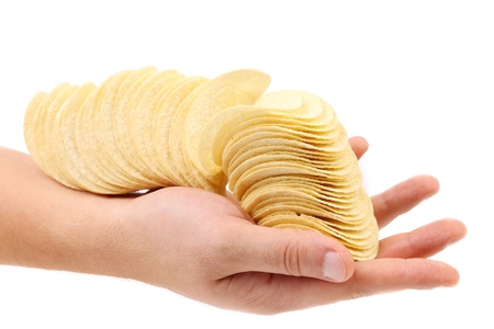 Hand holds chips. Isolated on a white background.の写真素材
