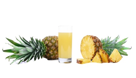 Pineapple juice in a glass and slices の写真素材