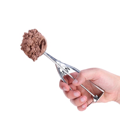 Hand holds scoop with chocolate ice cream. White background.の写真素材