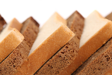 Slices of brown and white bread. Close up.