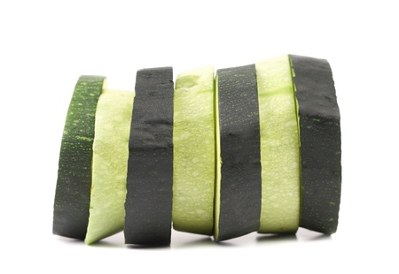 Green and white slices of zucchini on white backgroundの写真素材