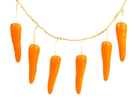 Close-up of a toy carrot. Isolated on a white background.の写真素材