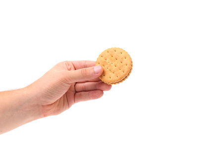 Hand holds cookie biscuits with filling.white background