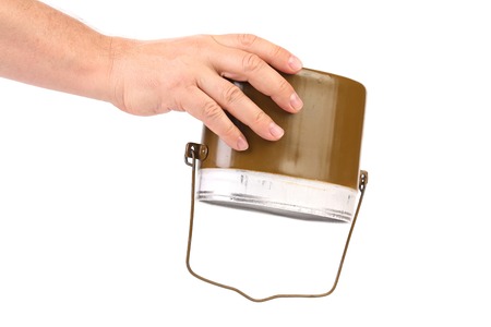 Hands holds green aluminum military mess-tin. Isolated on a white background.の写真素材