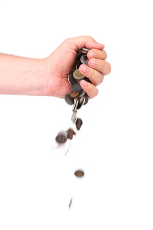 Coins spilling out of hand. Isolated on a white background.の写真素材