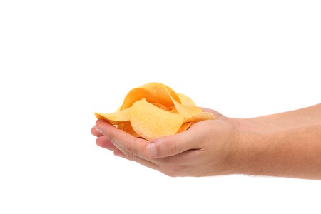 Hand holds potato chips. Isolated on a white backgroundの写真素材