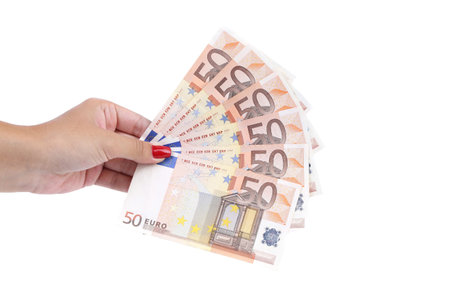 Hand holding fifty-euro notes. Isolated on a white background.