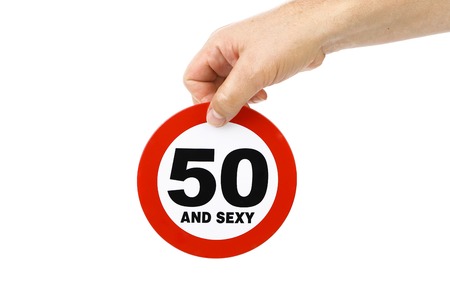 Hand holds road sign concept. Isolated on a white background.の写真素材