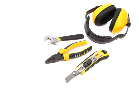 Repair tools and protective ear muffs. Isolated on white background.