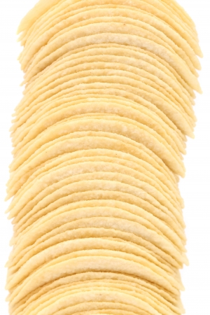 Stack of potato chips. Vertical. Isolated on a white background.の写真素材