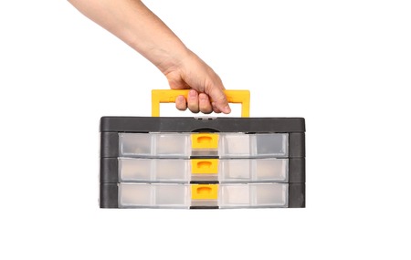 Working toolbox in hand. Isolated on a white background.の写真素材