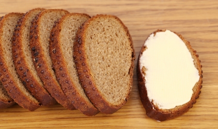 Slices of bread and butter isolated on a white background.の写真素材