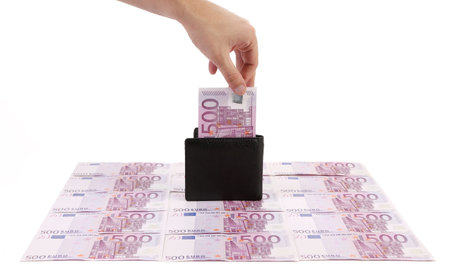 Wallet with five hundreds euro banknotes. On a banknotes background