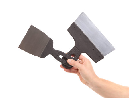 Hand holds construction spatula. Isolated on a white background.